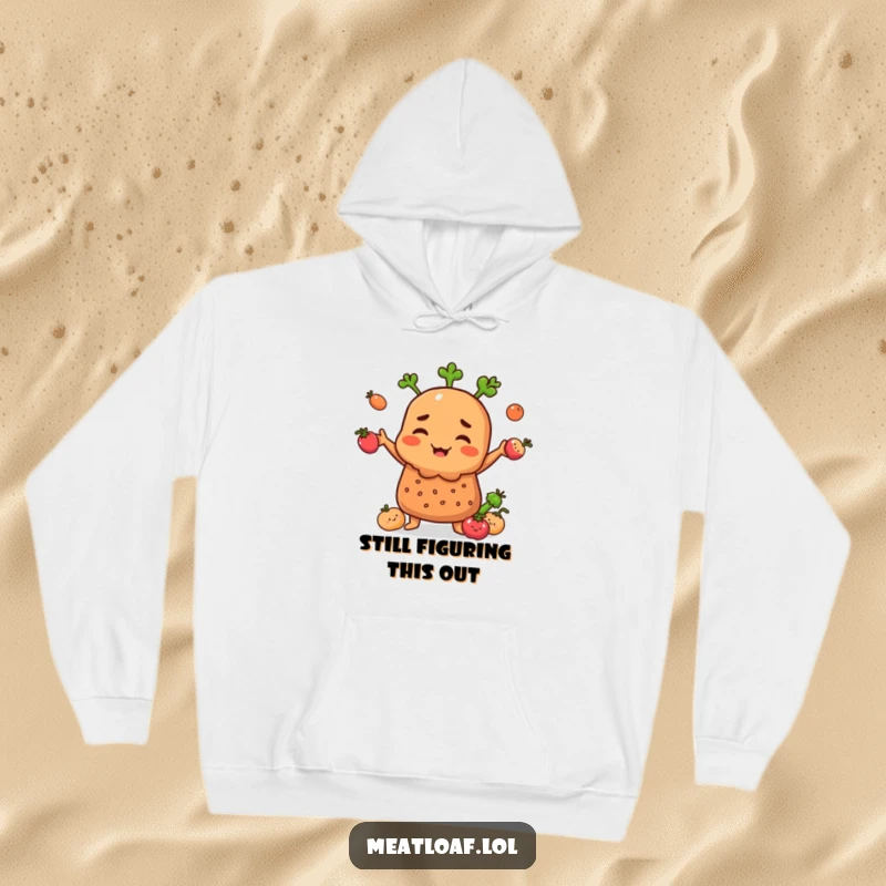 Funny Meatloaf character on a hoodie, juggling smiling vegetables with a determined and cheerful look.